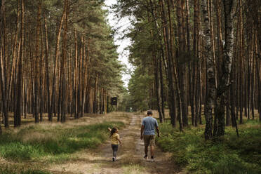 Girl with mature man hiking in forest - TOF00094