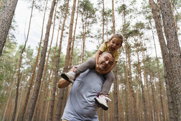 Mature man and girl having fun in forest - TOF00104