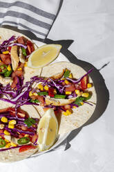 Hausgemachte mexikanische Tacos mit frischem Gemüse und Huhn mit starkem Licht auf weißem Hintergrund. Gesundes Essen. Typisch mexikanisch - ADSF37535