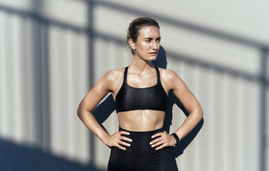 Beautiful woman with arms akimbo taking break after exercising - OIPF02369