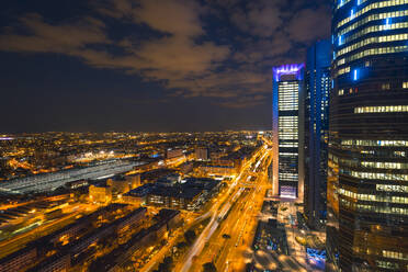 From above of modern district of Madrid with skyscrapers in evening sunlight under beautiful sky with clouds - ADSF37830