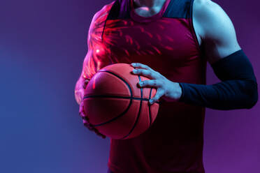 Creative studio shot of basketball player in the studio using color gels and projector lights. - ADSF38103