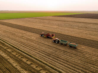 Combine harvester and tractor in field - NOF00628