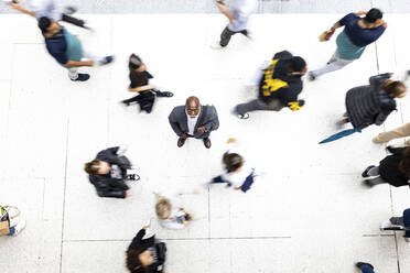 Senior businessman amidst commuters at railroad station - WPEF06463