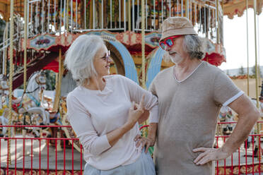 Mature woman with senior man having fun in amusement park - YTF00029