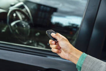 Hand of businesswoman using car key - VPIF07205