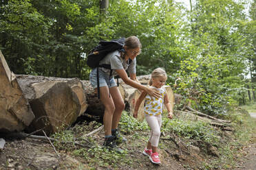 Smiling woman with daughter in forest - DWF00600