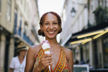 Happy beautiful young woman holding ice cream - DCRF01402