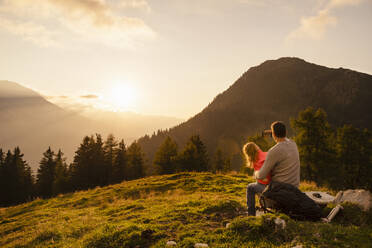 Mature man with daughter taking selfie through smart phone sitting on bench - DIGF18800