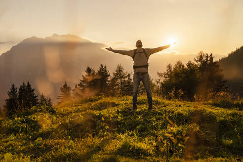 Smiling man standing with arms outstretched - DIGF18804