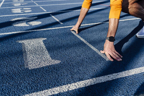 Sportsman at starting line of running track - ASGF02886