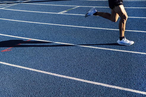 Mature athlete running on track - ASGF02888