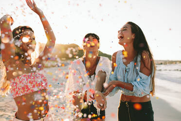 young women celebrating in bikini party, joyful female friends having a  party at home with flags colorful Stock Photo