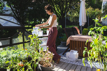 Mature woman working on terrace - DMMF00110