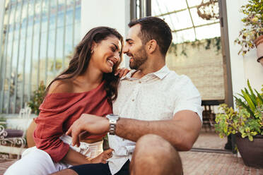 Happy couple hugging while spending time together in balcony at home - a  Royalty Free Stock Photo from Photocase