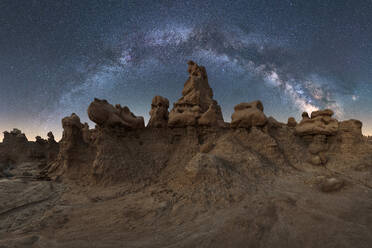 Unusual rock formations located against magnificent starry sky at night in dry desert - ADSF38787