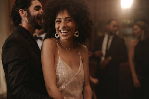 Loving young couple enjoying dancing at a nightclub. Cheerful man and woman dancing at gala night. - JLPPF00699