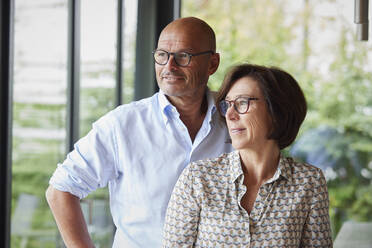 Thoughtful woman with man standing together at home - RBF08999