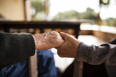 Elderly couple shaking hands - ADSF38913