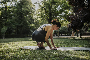 Yoga instructor exercising in park - MRRF02493