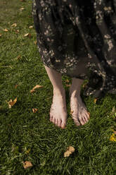 Woman standing on grass at park - LESF00316