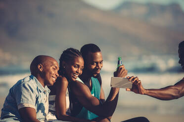 Group of happy friends having fun together and taking selfie using mobile phone. Self portrait at beach party. - JLPSF00066