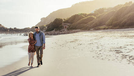 Full length outdoor shot of loving senior couple walking along the beach. Mature man and woman strolling on the sea shore. - JLPSF00468