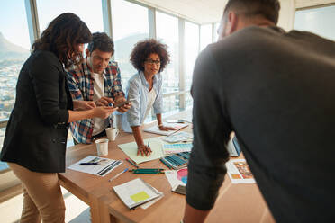 Ein Team von jungen Fachleuten arbeitet in einem kreativen Büro zusammen. Ein Business-Team arbeitet an einem kreativen Projekt. - JLPSF00591