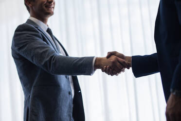 Business men shaking hands with each other after a successful deal. Focus on business people hand shake. - JLPSF01351