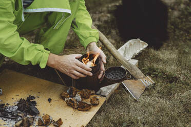 Beekeeper burning tinder fungus in bee smoker - IEF00113