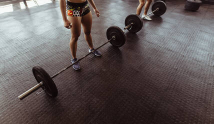 Healthy people at gym workout with heavy weights. Woman before exercising with barbell in gym. - JLPSF02050