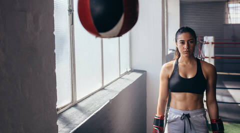 Boxer Woman Wearing Sports Bra and Boxing Gloves Stock Photo