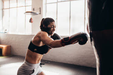 Female boxers bumping boxing gloves before fighting stock photo