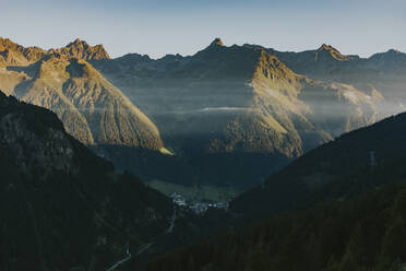 Austria, Tyrol, Ischgl, Mountain village at foggy morning - DMGF00848