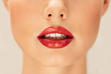 Close up portrait of woman with red lipstick. Cropped shot of beautiful lips of a young woman. - JLPSF03273