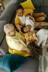 Smiling parents with daughter and son enjoying at home - VIVF00071