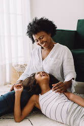 African mother and daughter having fun time together. Woman spending time with her child at home. - JLPSF04339