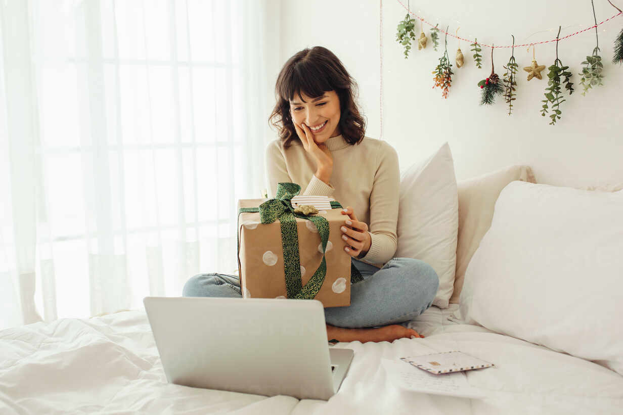 Free Photo  Woman opening her present on christmas