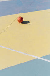 Basket ball in court on sunny day - MEUF08164