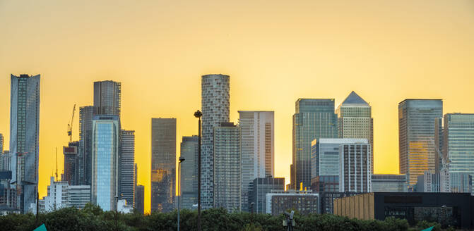 UK, England, London, Canary Wharf skyline at sunset - TAMF03500