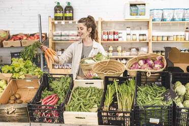 Happy customer buying vegetables in greengrocer shop - PCLF00156