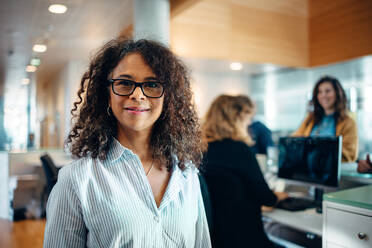 Portrait of a confident businesswoman standing in office. Mature woman working as an administrator in municipal office looking at camera. - JLPSF05167