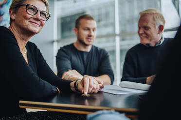 Senior businesswoman in meeting. Female professional smiling during a meeting in office. - JLPSF05223