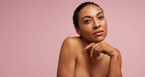 Woman with flawless skin staring at camera. Beautiful female having prefect skin against pink background. - JLPSF05802