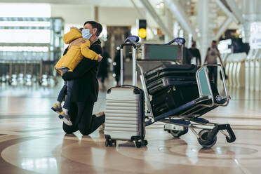 Mutter und Sohn am Flughafen während der Pandemie. Mutter umarmt ihren Sohn beim Warten auf den Flug am Flughafen. - JLPSF06062