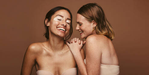 Young women embracing their natural bodies in a studio. Two happy