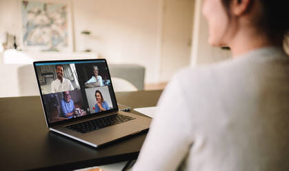 Woman having a video conference with friends. Family meeting online over a video call. - JLPSF06293