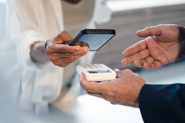 Woman paying through smart phone - JOSEF14157