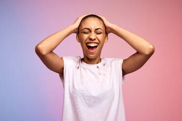 Happy woman with shaved head on gradient background. Confident and liberated female with short hair. - JLPSF06430