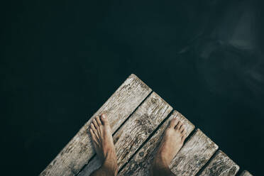 Mann steht auf einem Holzsteg über dem Monticolo-See - DMGF00877